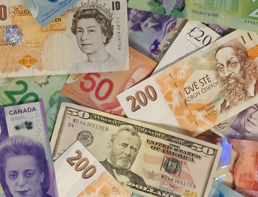 A UK Shopify seller reconciling multi-currency payouts and exchange rates on a laptop