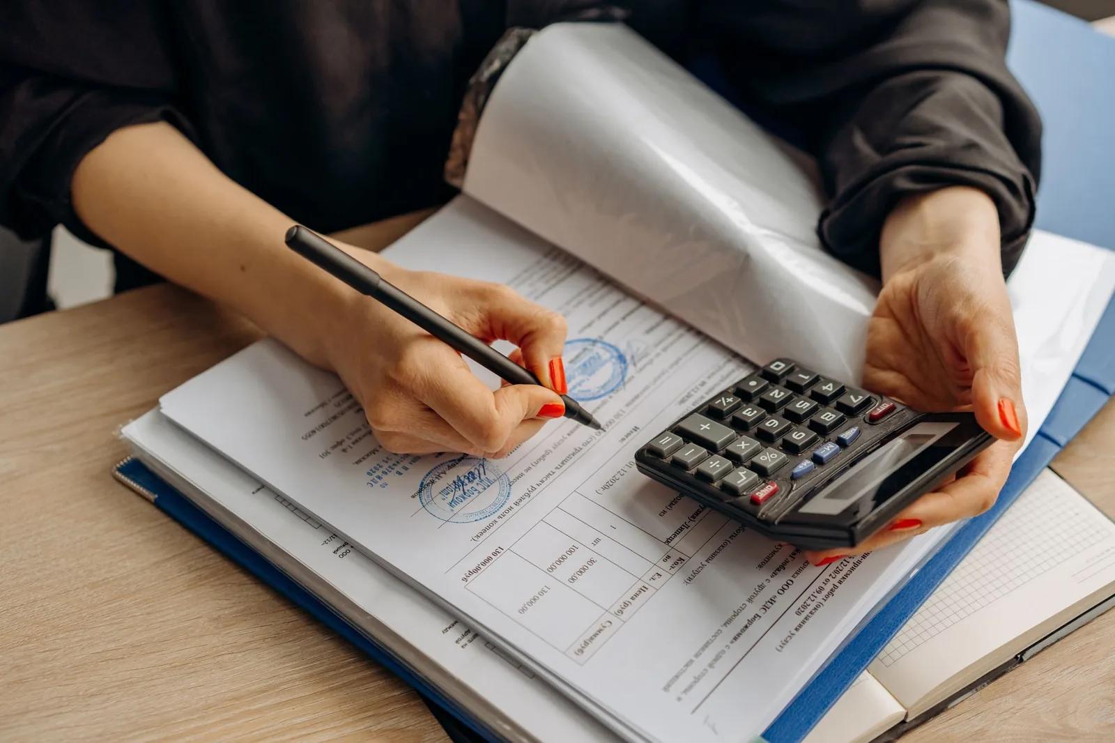 A small business owner reviewing an accounts receivable subledger and general ledger control account on a laptop running cloud accounting software