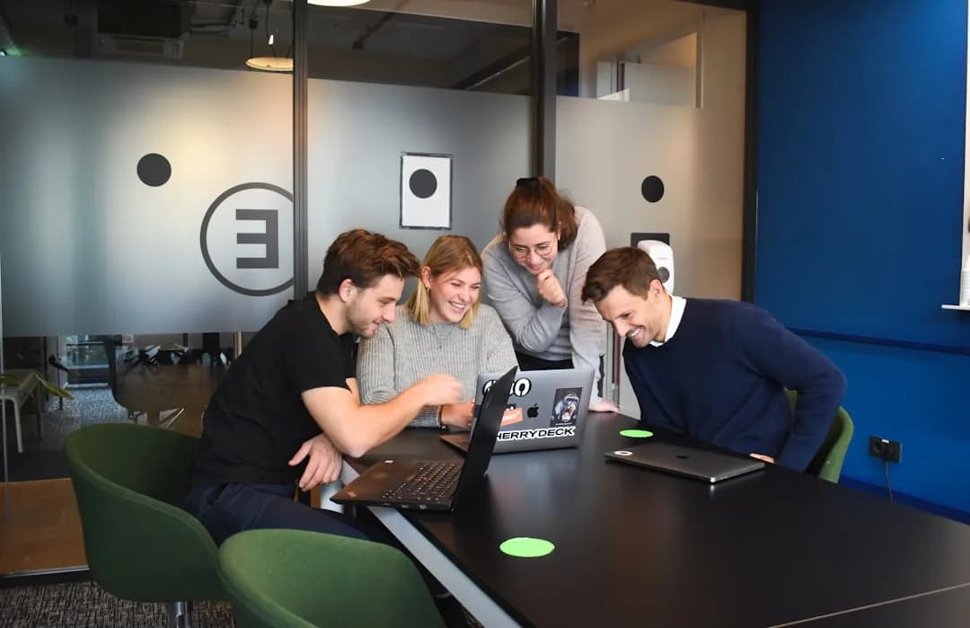 Company director at a desk comparing salary and dividend take-home pay on a laptop