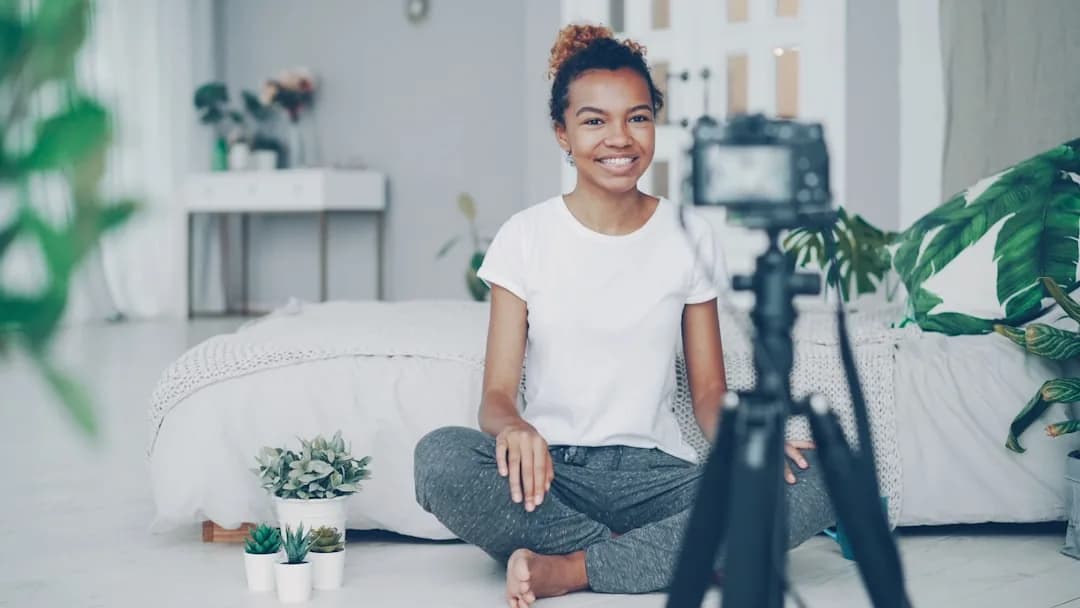 A UK TikTok creator filming a video on a phone and checking earnings on a laptop