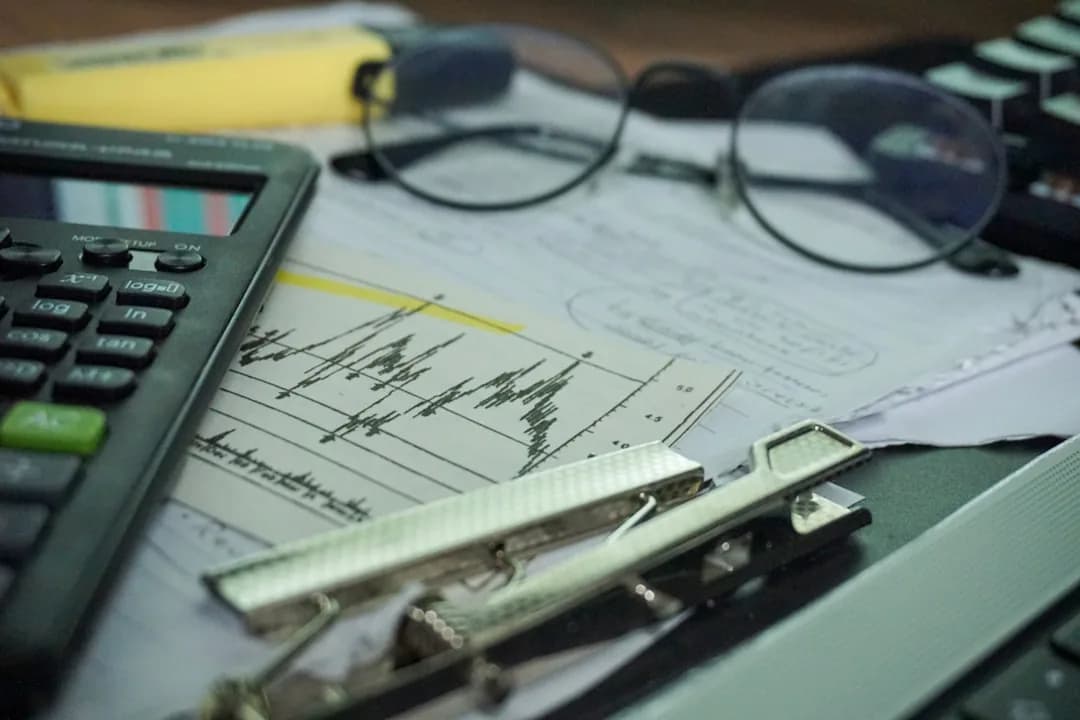 A UK ecommerce seller reconciling a TikTok Shop settlement report and fee invoices on a laptop