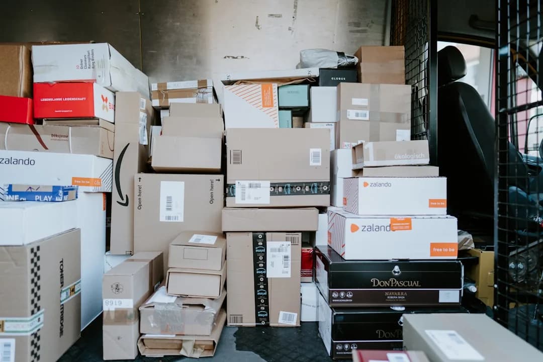 A UK ecommerce seller packing an order for a US customer and checking state sales tax obligations on a laptop