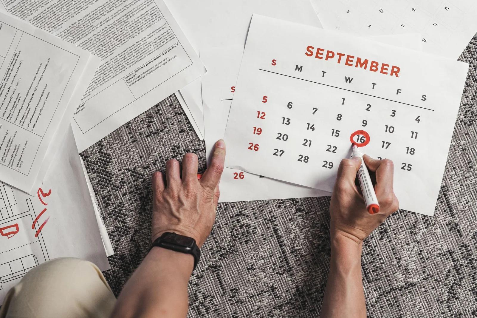 Remote worker with a passport and laptop counting days on a calendar to check UK tax residence