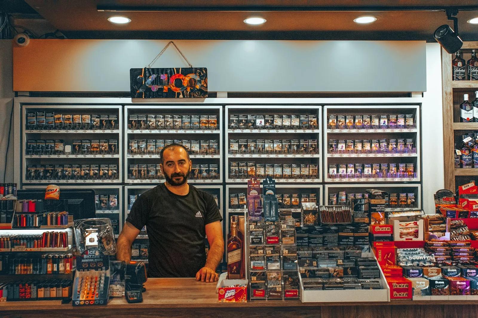 A UK vape shop retail counter with e-liquid bottles and vaping devices on display