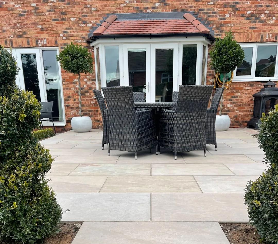 A landscaper laying turf in the garden of a newly built house on a residential development