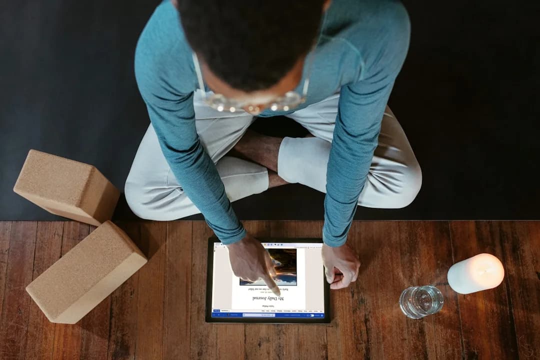 A Vinted Pro seller packing parcels at home while reviewing earnings on a laptop