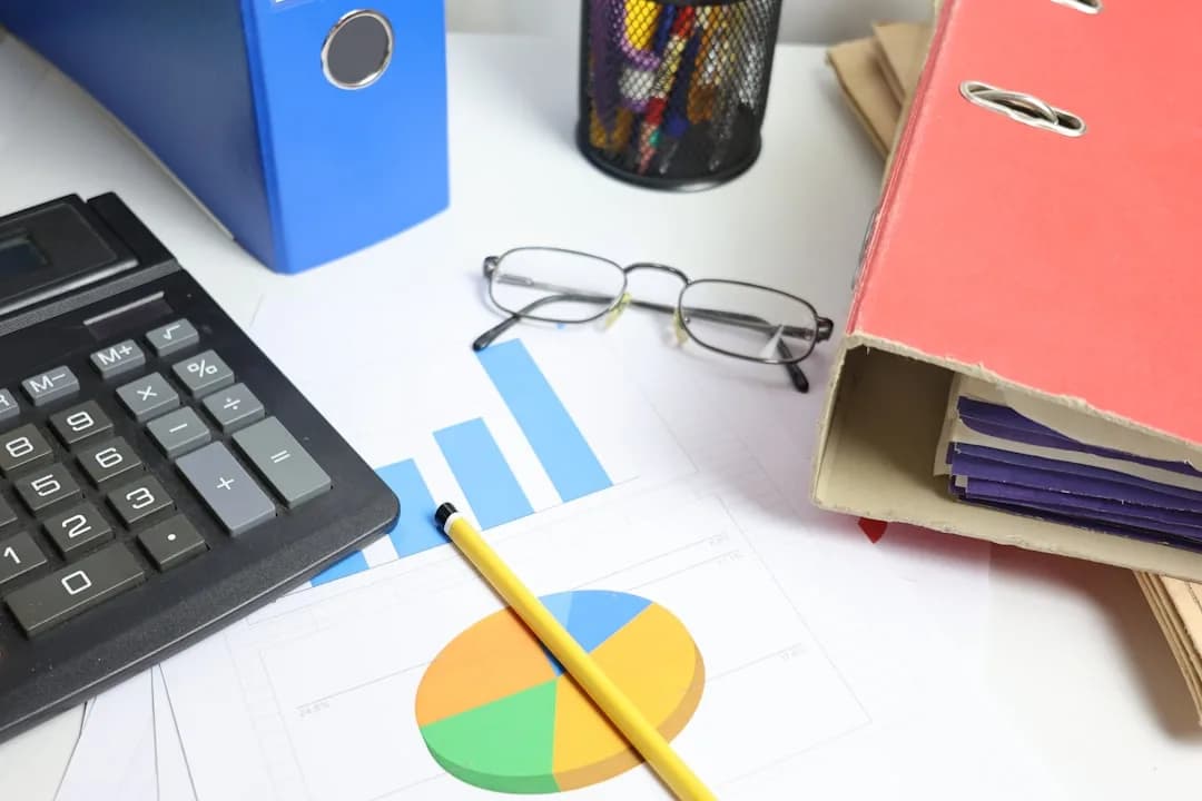 A UK employee checking a payslip at a desk to find the employer PAYE tax reference