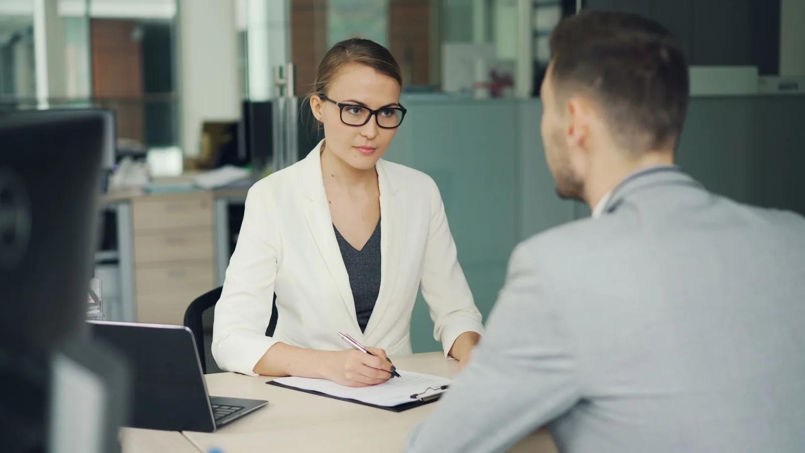 Company director reviewing closure and liquidation paperwork with an accountant at a desk