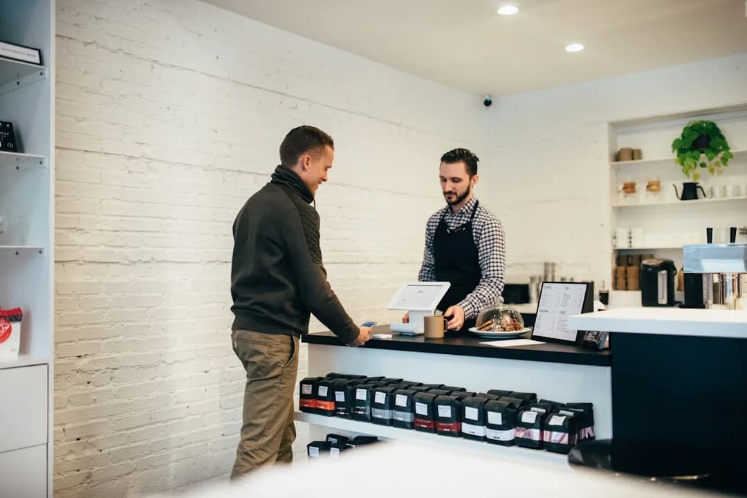 An ecommerce owner checking rolling 12-month sales on a laptop running a WooCommerce store