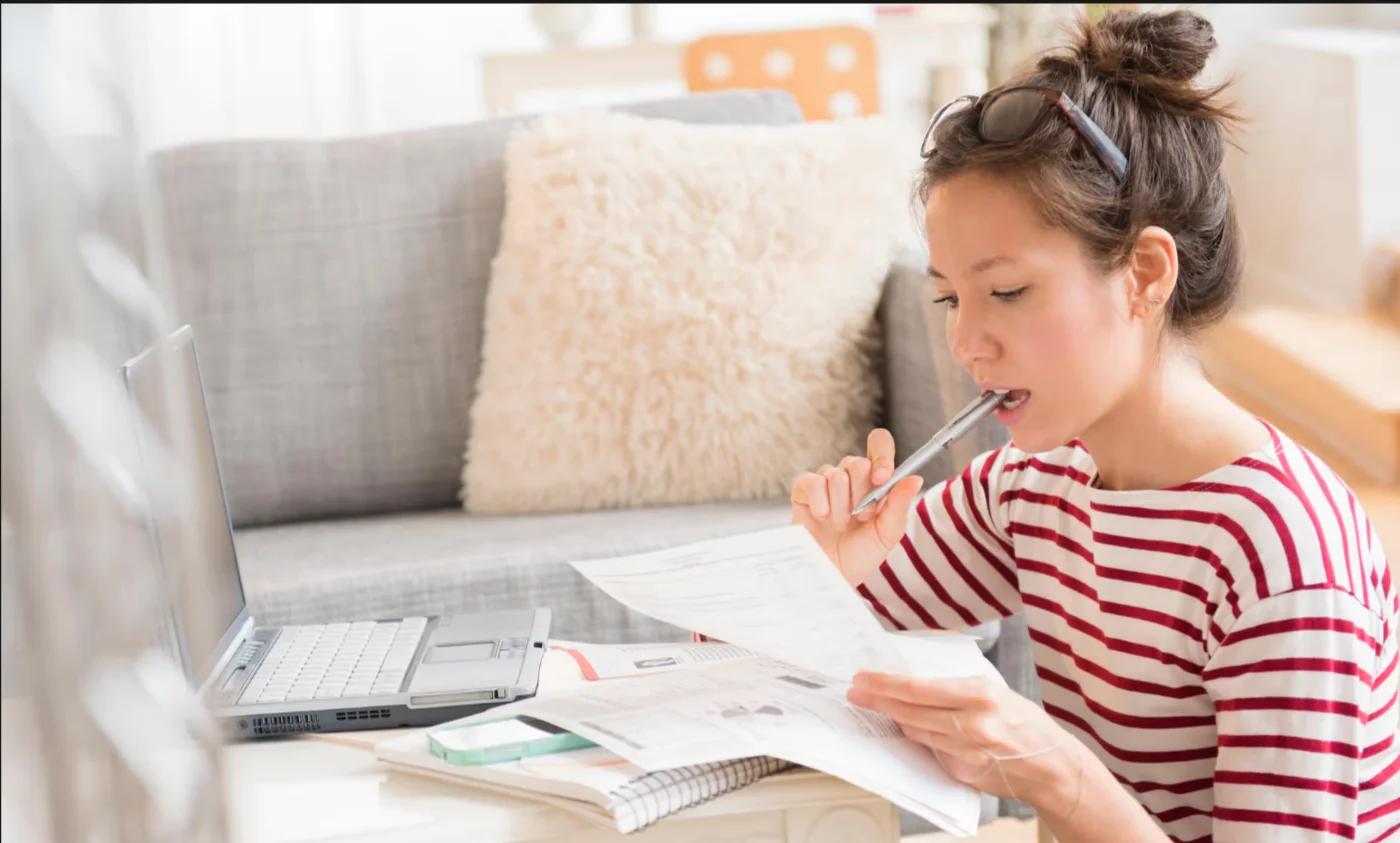 A Accountant reading and writing in a notebook.