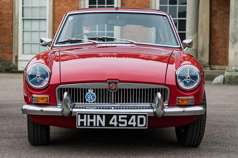 Restored classic cars on display at a dealership