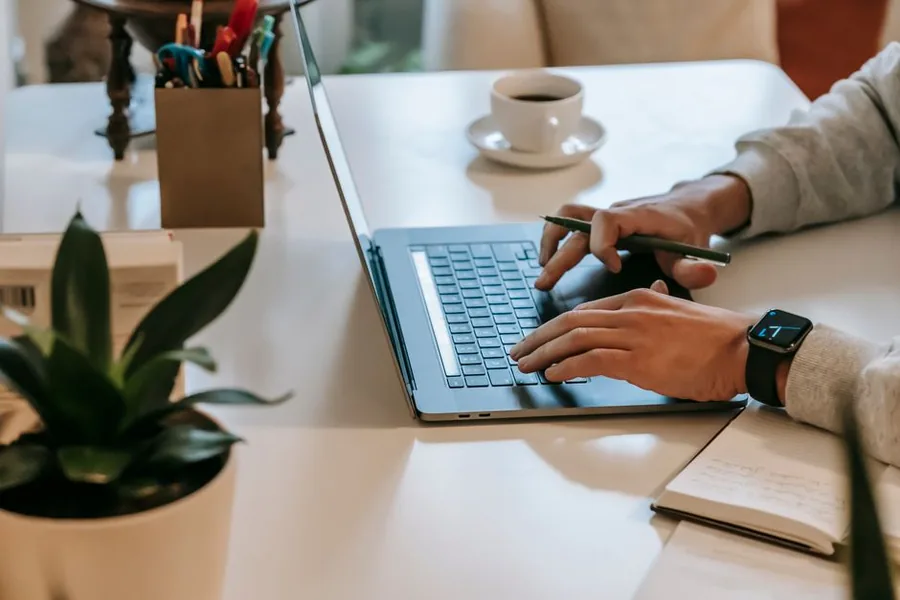 A self-employed worker completing their Self Assessment tax return online at a desk ahead of the HMRC filing deadline