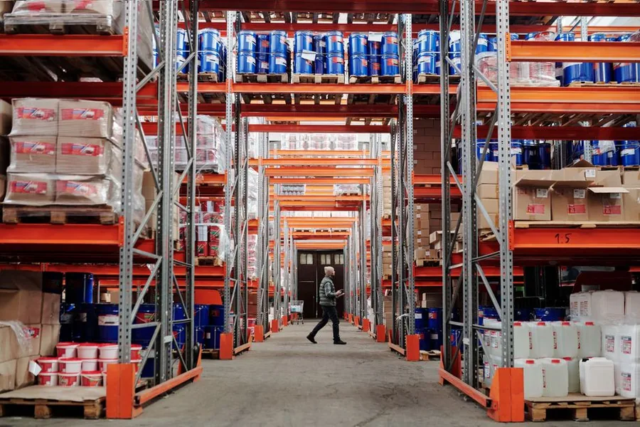 Stock stacked on pallet racking in a fulfilment warehouse, where FBA commingling can mix one seller's inventory with another's Stock stacked on pallet racking in a fulfilment warehouse, where FBA commingling can mix one seller's inventory with another's