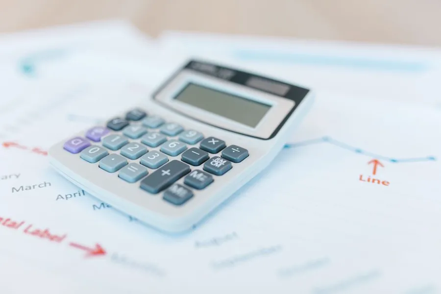 A calculator resting on financial charts as a UK business works out its Annual Investment Allowance claim on new equipment A calculator resting on financial charts as a UK business works out its Annual Investment Allowance claim on new equipment