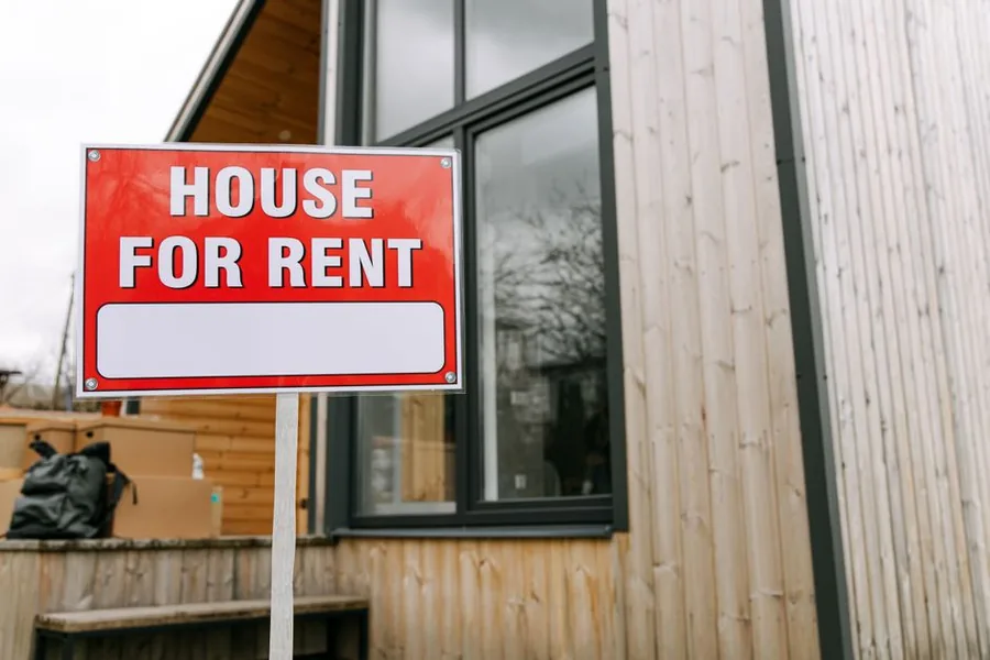 A House For Rent sign outside a modern UK rental property let by a private landlord A House For Rent sign outside a modern UK rental property let by a private landlord