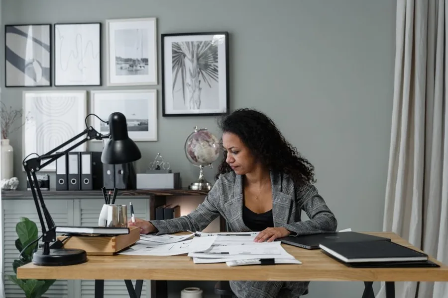 A UK employer reviewing staff benefit records at a home office desk before completing the annual P11D return A UK employer reviewing staff benefit records at a home office desk before completing the annual P11D return