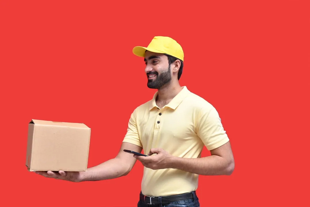 UK ecommerce seller checking a VAT return on a laptop in a small warehouse