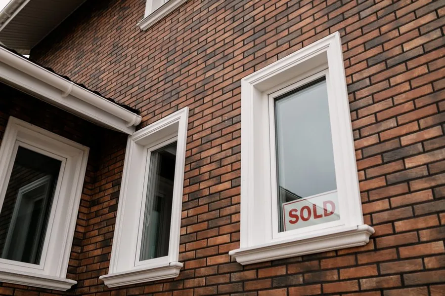 A sold sign in the window of a UK brick house, marking the kind of property disposal that can trigger a capital gains tax bill A sold sign in the window of a UK brick house, marking the kind of property disposal that can trigger a capital gains tax bill