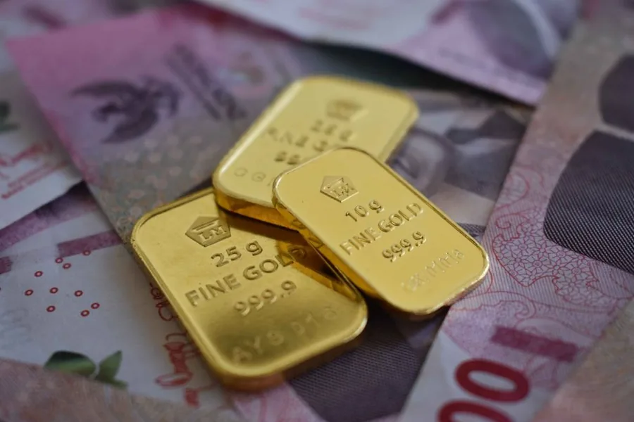 Fine gold bars stamped 999.9, the kind of stock a cash-for-gold dealer weighs, buys and records for VAT Fine gold bars stamped 999.9, the kind of stock a cash-for-gold dealer weighs, buys and records for VAT