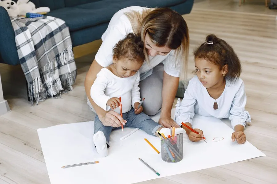 A childminder helping two young children draw at home, the kind of sole trader work rarely suited to a limited company A childminder helping two young children draw at home, the kind of sole trader work rarely suited to a limited company