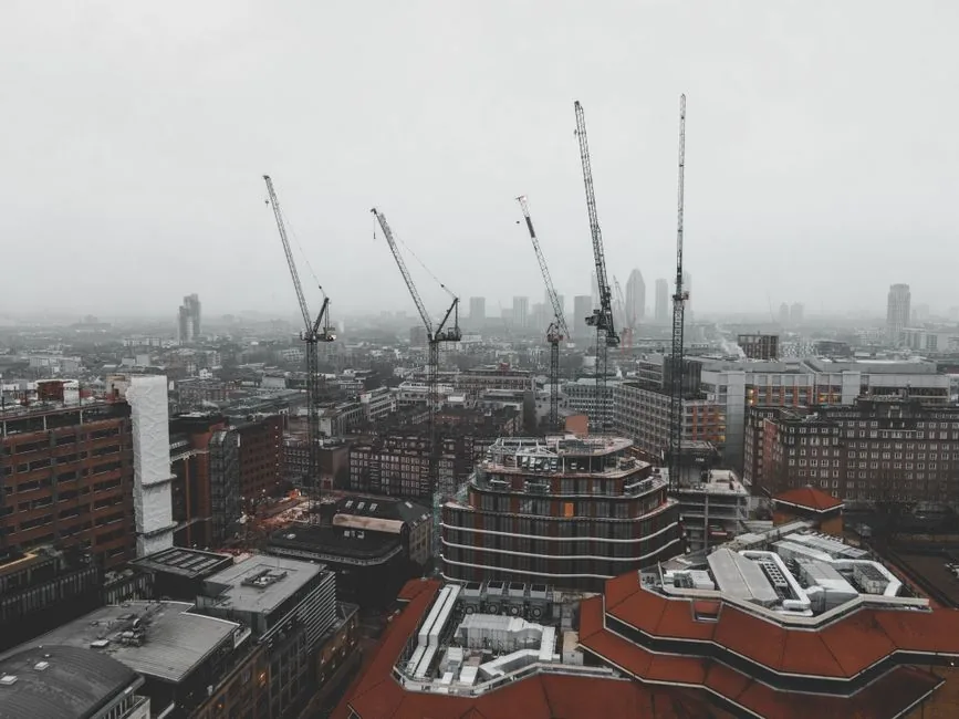 Tower cranes over new-build towers in a Manchester development, the scale of construction turnover the CIS gross payment test measures Tower cranes over new-build towers in a Manchester development, the scale of construction turnover the CIS gross payment test measures