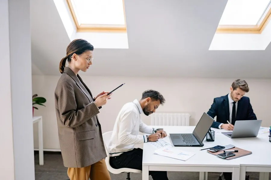 Company directors reviewing paperwork and filings together in a modern UK office Company directors reviewing paperwork and filings together in a modern UK office