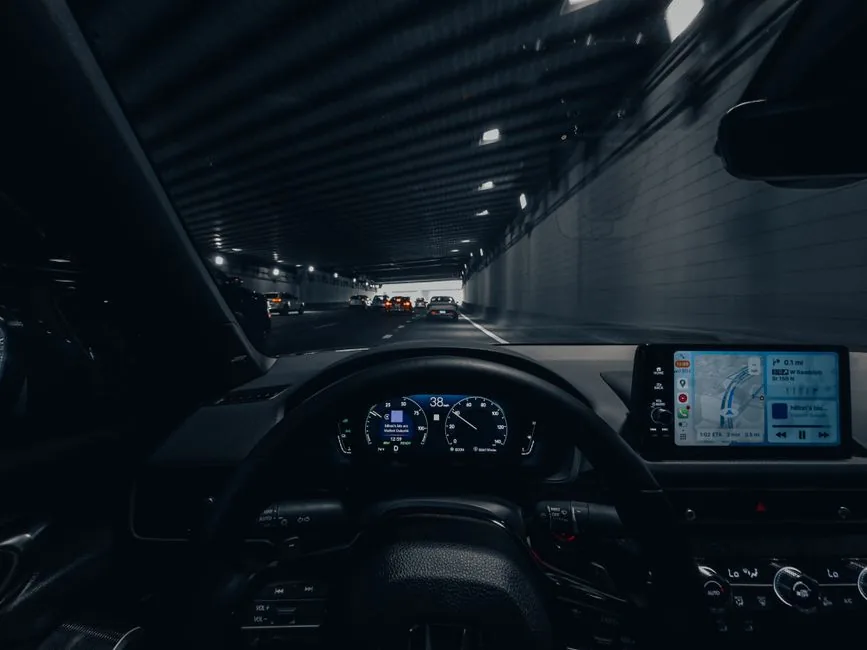 The driver's-eye view from a modern company car, digital dashboard and sat-nav lit up on the road The driver's-eye view from a modern company car, digital dashboard and sat-nav lit up on the road