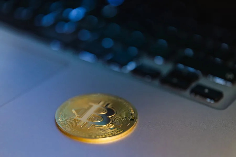 A single Bitcoin coin resting on a laptop, reflecting the record-keeping crypto investors need for a UK tax return A single Bitcoin coin resting on a laptop, reflecting the record-keeping crypto investors need for a UK tax return