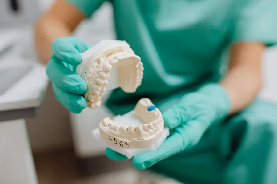 A dentist reviewing practice paperwork chairside, the kind of year-end figures that show how a UK dental practice is really performing A dentist reviewing practice paperwork chairside, the kind of year-end figures that show how a UK dental practice is really performing