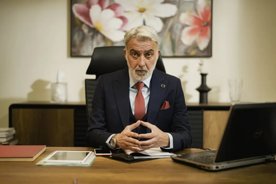 A company director reviewing statutory paperwork and accounts at his desk in a UK office A company director reviewing statutory paperwork and accounts at his desk in a UK office