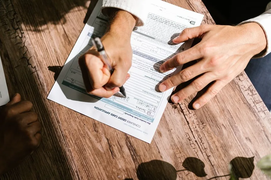 A company director signing a loan agreement across a desk, the kind of drawing that builds up a director's loan account A company director signing a loan agreement across a desk, the kind of drawing that builds up a director's loan account