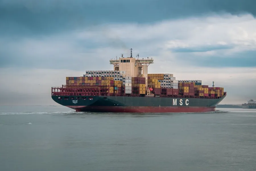 A container ship carrying export cargo across open water, bound for customers overseas A container ship carrying export cargo across open water, bound for customers overseas