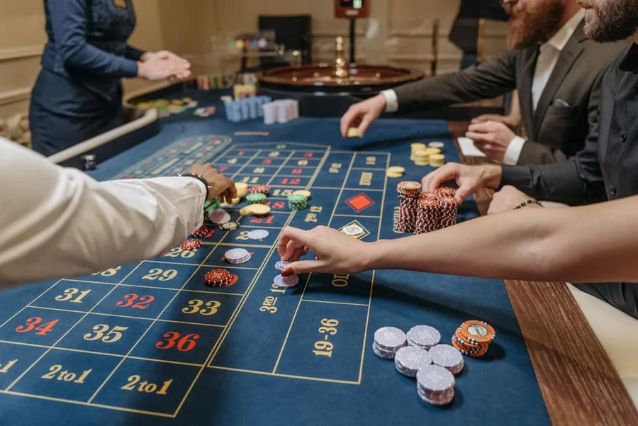 Players placing chips at a roulette table, the kind of gambling winnings that stay tax-free in the UK Players placing chips at a roulette table, the kind of gambling winnings that stay tax-free in the UK