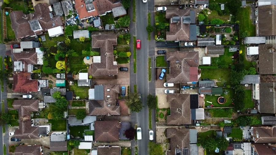 Aerial view of a British residential street where homes sit side by side with their immediate neighbours, the setting for HMO licensing Aerial view of a British residential street where homes sit side by side with their immediate neighbours, the setting for HMO licensing