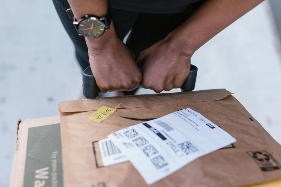 Sealing and labelling a parcel, part of the eBay returns process sellers must record for refunds and VAT Sealing and labelling a parcel, part of the eBay returns process sellers must record for refunds and VAT