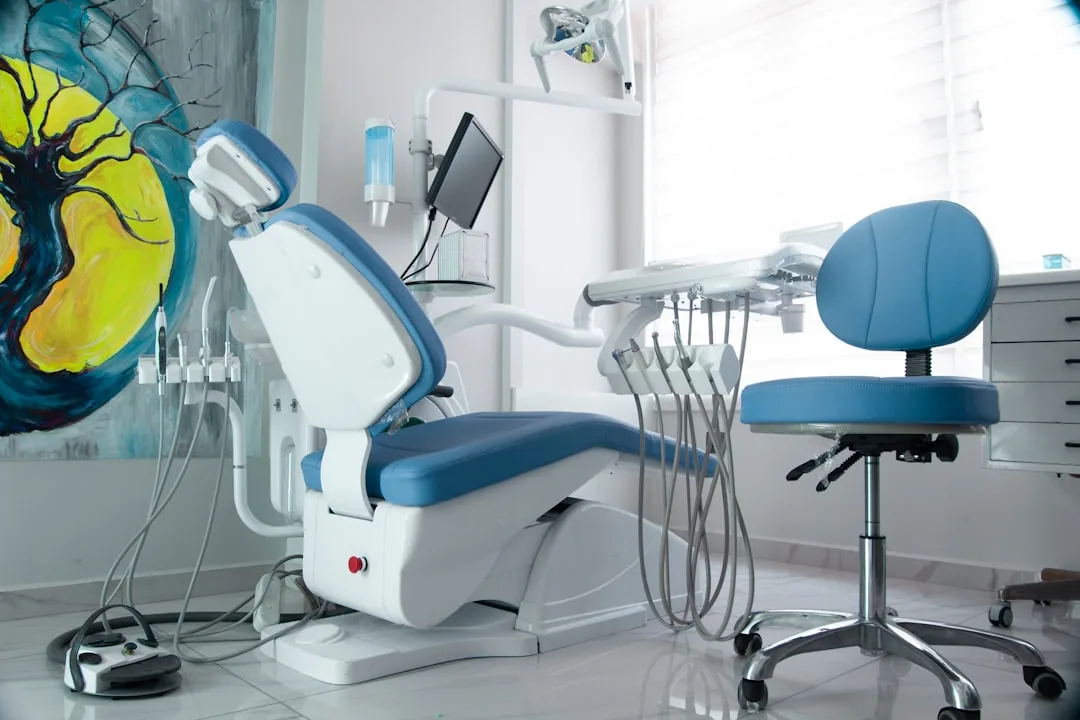 An associate dentist reviewing tax paperwork at a practice desk to compare PAYE and Self Assessment