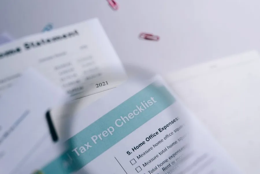 A tax preparation checklist beside an income statement, the paperwork to gather before filing your first Self Assessment return. A tax preparation checklist beside an income statement, the paperwork to gather before filing your first Self Assessment return.