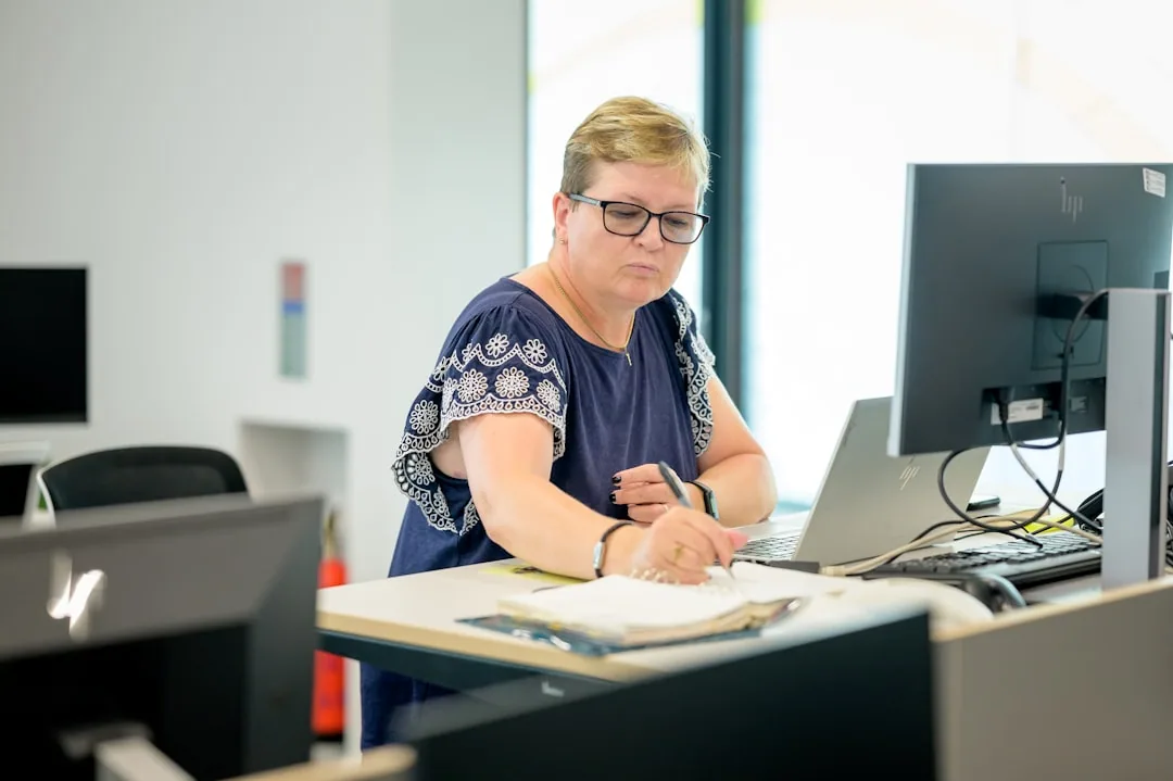 An accountant preparing a UK limited company's statutory accounts under FRS 102 at a desk with a laptop