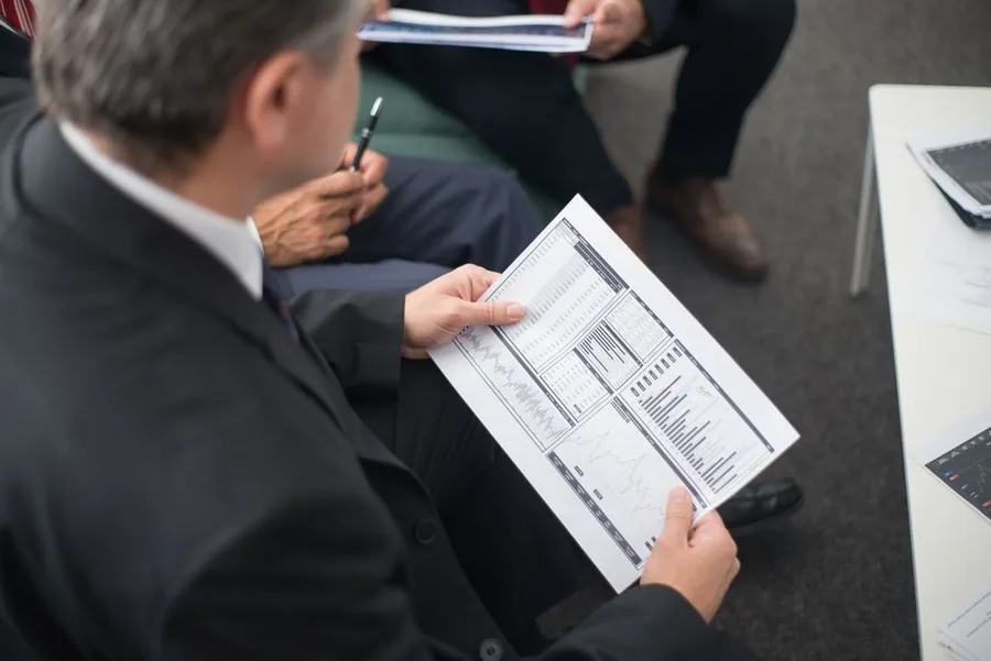 A senior finance leader reviewing detailed performance data with executives during a fractional CFO advisory session