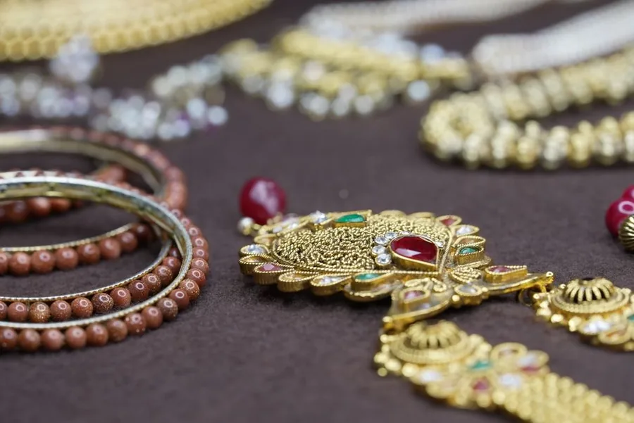 Close-up of gold jewellery and gemstone pieces, the kind of second-hand stock a UK dealer accounts for under the VAT margin scheme Close-up of gold jewellery and gemstone pieces, the kind of second-hand stock a UK dealer accounts for under the VAT margin scheme