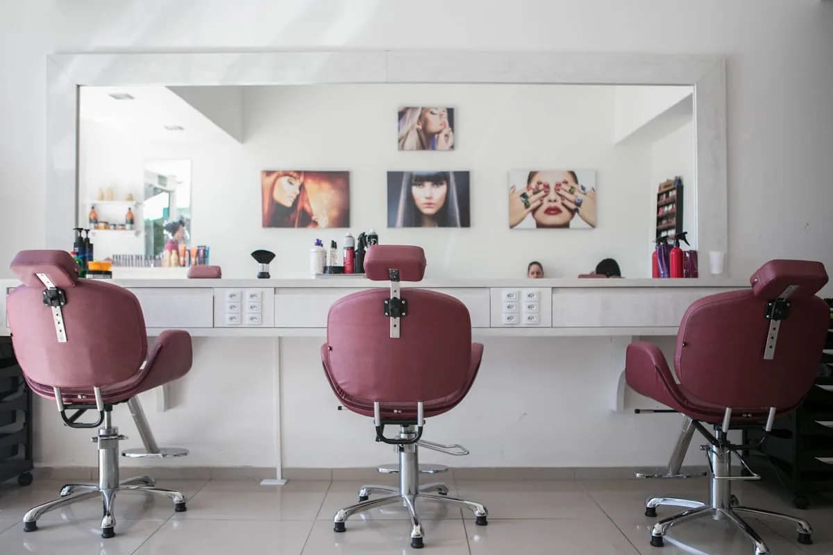 Self-employed hairdresser renting a salon chair, reviewing expenses and tips for their tax return