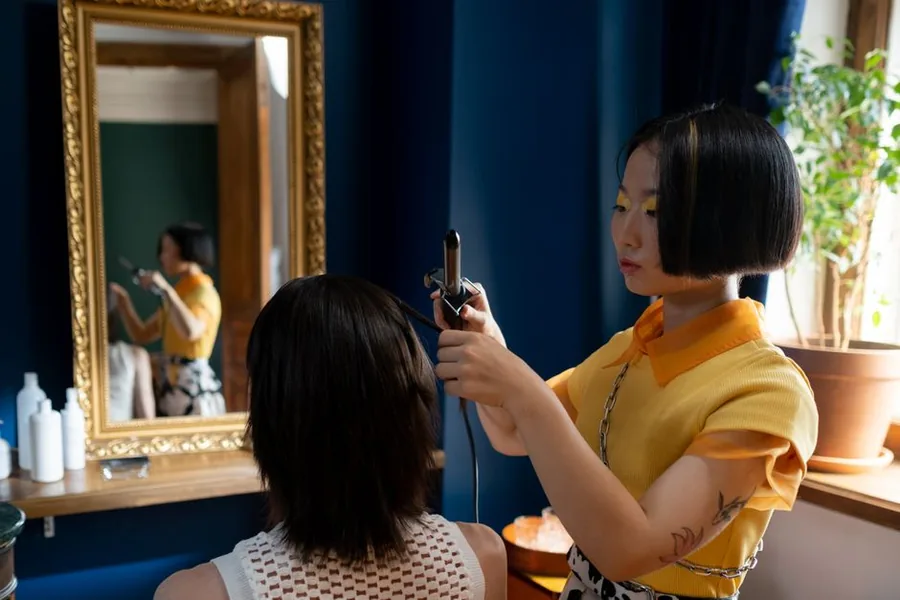 A salon stylist styling a client's hair, the kind of hands-on skill that raises questions about training costs and tax relief A salon stylist styling a client's hair, the kind of hands-on skill that raises questions about training costs and tax relief
