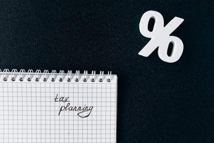 A tax planning notebook beside a percentage symbol, the kind of review that surfaces overpaid tax to reclaim from HMRC A tax planning notebook beside a percentage symbol, the kind of review that surfaces overpaid tax to reclaim from HMRC