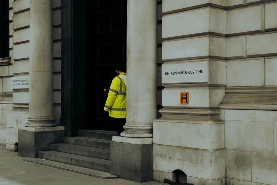 A person walking into the HM Revenue and Customs building in Whitehall, London A person walking into the HM Revenue and Customs building in Whitehall, London