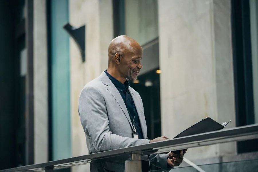 A UK limited company director reviewing financial paperwork while weighing up a salary and dividend split A UK limited company director reviewing financial paperwork while weighing up a salary and dividend split