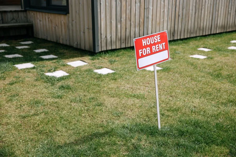 A House For Rent board outside a let property, with moving boxes at the door as an inherited home is prepared for tenants A House For Rent board outside a let property, with moving boxes at the door as an inherited home is prepared for tenants