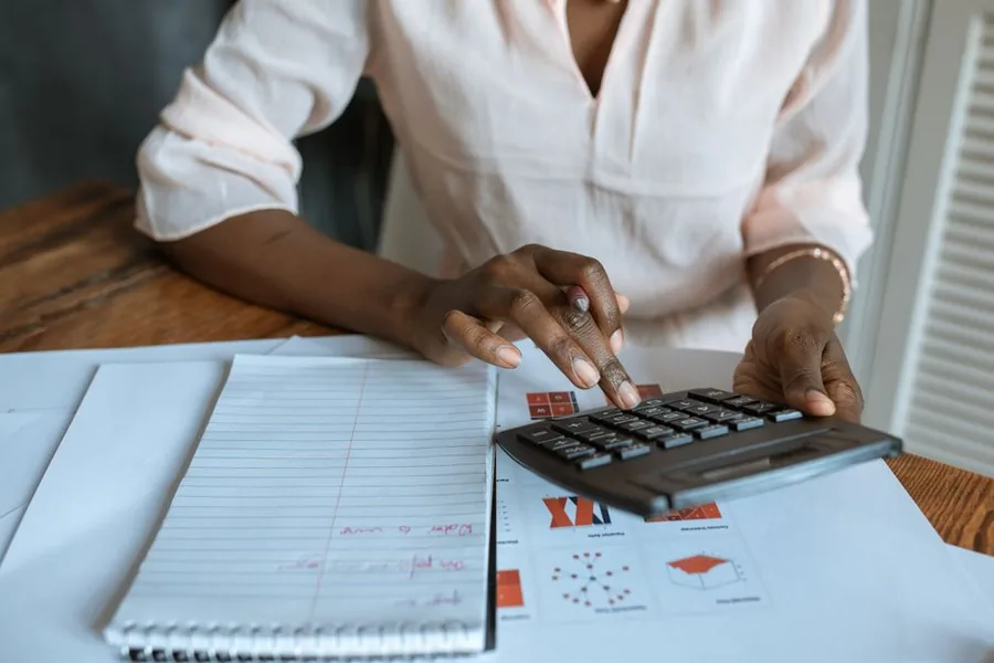 Working out client disbursements and markups on a calculator against financial summaries