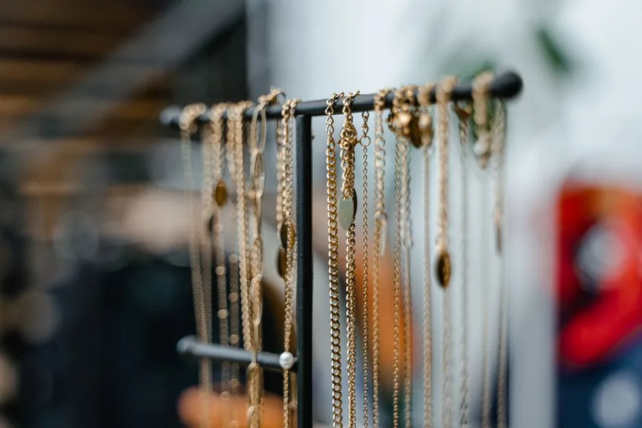Gold chains and necklaces on a display stand in a jeweller's shop Gold chains and necklaces on a display stand in a jeweller's shop