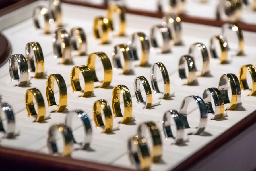 Gold and silver rings arranged in a jeweller's display tray, the kind of stock counted during a shop stocktake