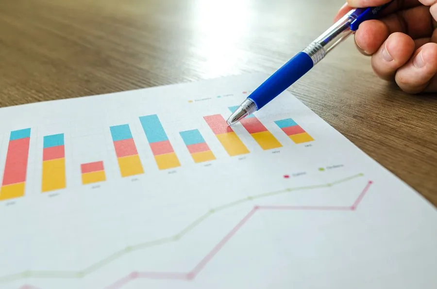 A business owner analysing monthly performance charts with an upward trend to plan for financial growth A business owner analysing monthly performance charts with an upward trend to plan for financial growth